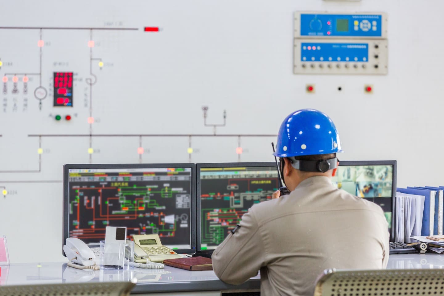 Factory control room with PLC and SCADA systems for monitoring industrial equipment and production processes.
