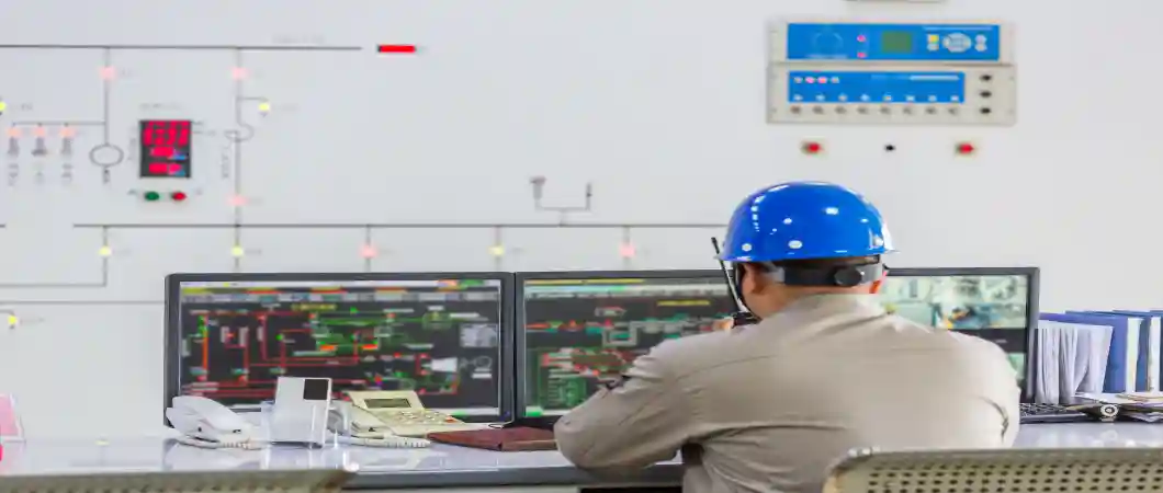 Factory control room with PLC and SCADA systems for monitoring industrial equipment and production processes.